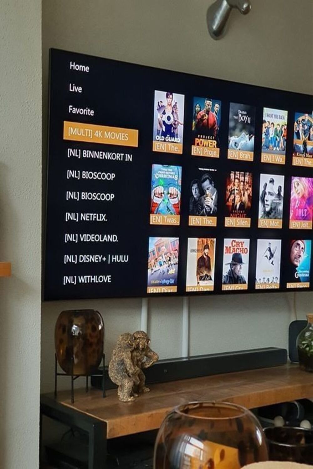 RobotIPTV customer browsing a large VOD movie library on a wall-mounted TV